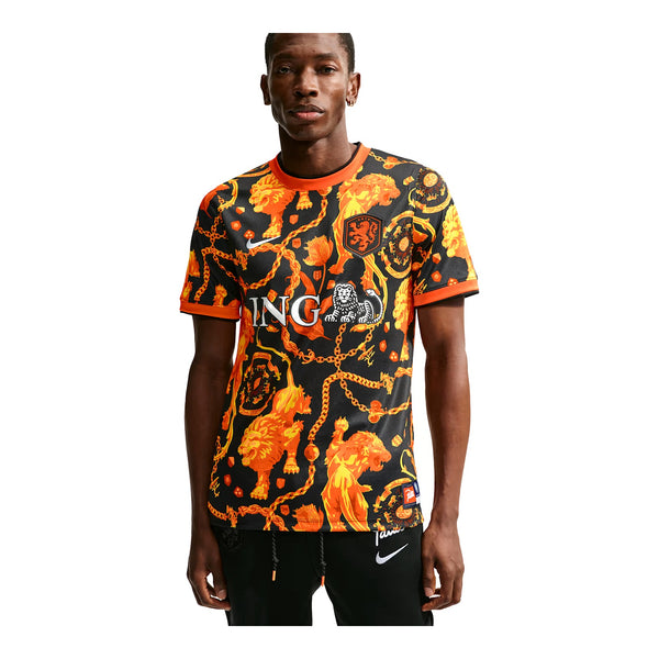 Person wearing a black and orange patterned sports jersey with visible branding on a white background