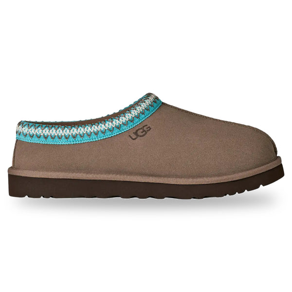 Brown slipper with blue and white patterned trim on a white background