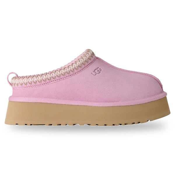 Pink slipper with brown sole on a white background