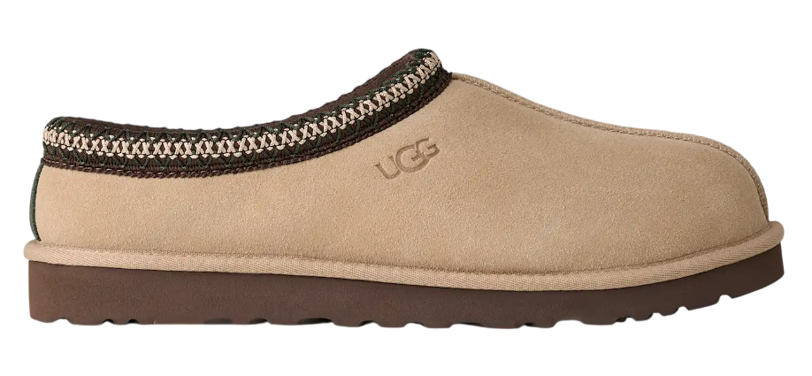 Beige UGG slipper with brown trim on a white background