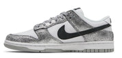 White sneaker with black swoosh logo and silver glittery side panel on a white background