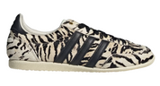 Zebra-patterned sneaker with black stripes on a white background