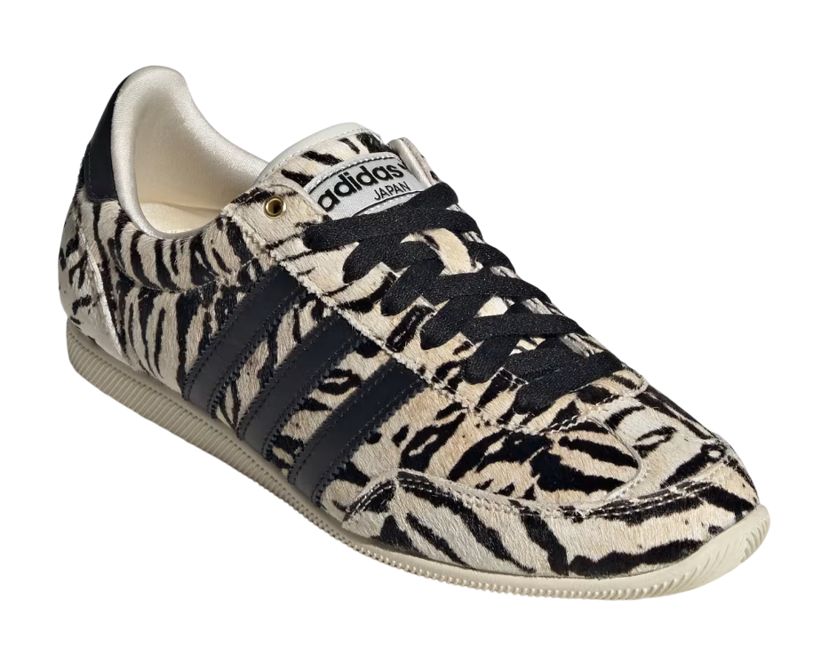 Adidas sneaker with tiger stripe pattern on a white background