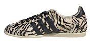 Sneaker with zebra pattern and three black stripes on a white background