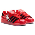 Red sneakers with black accents and a unique charm on a white background - Image 2