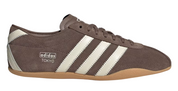 Brown Adidas sneaker with white stripes on a white background