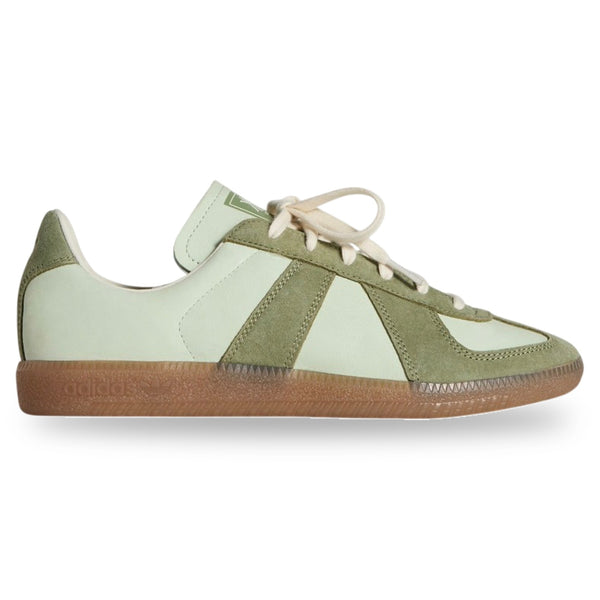 Green and white sneaker with brown sole on a white background