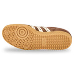 Close-up of a brown sneaker sole with white stripes on a white background - Image 5