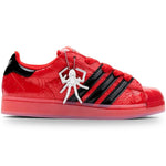 Red and black sneaker with a spider design on a white background - Image 1