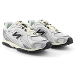 Pair of white New Balance sneakers with black accents on a white background - Image 2
