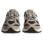 Pair of beige and black sneakers on a white background - Image 4