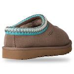 Brown UGG slipper with a blue and white trim on a white background - Image 4